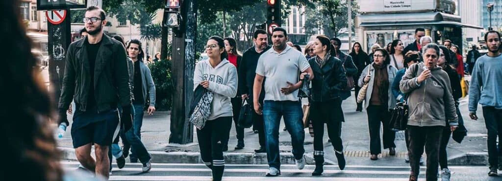 People crossing the street in a city landscape