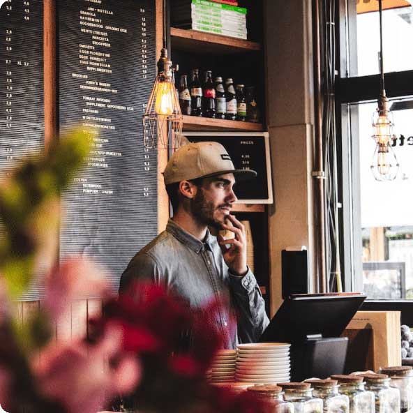 man with cap in coffee shop FintechOS